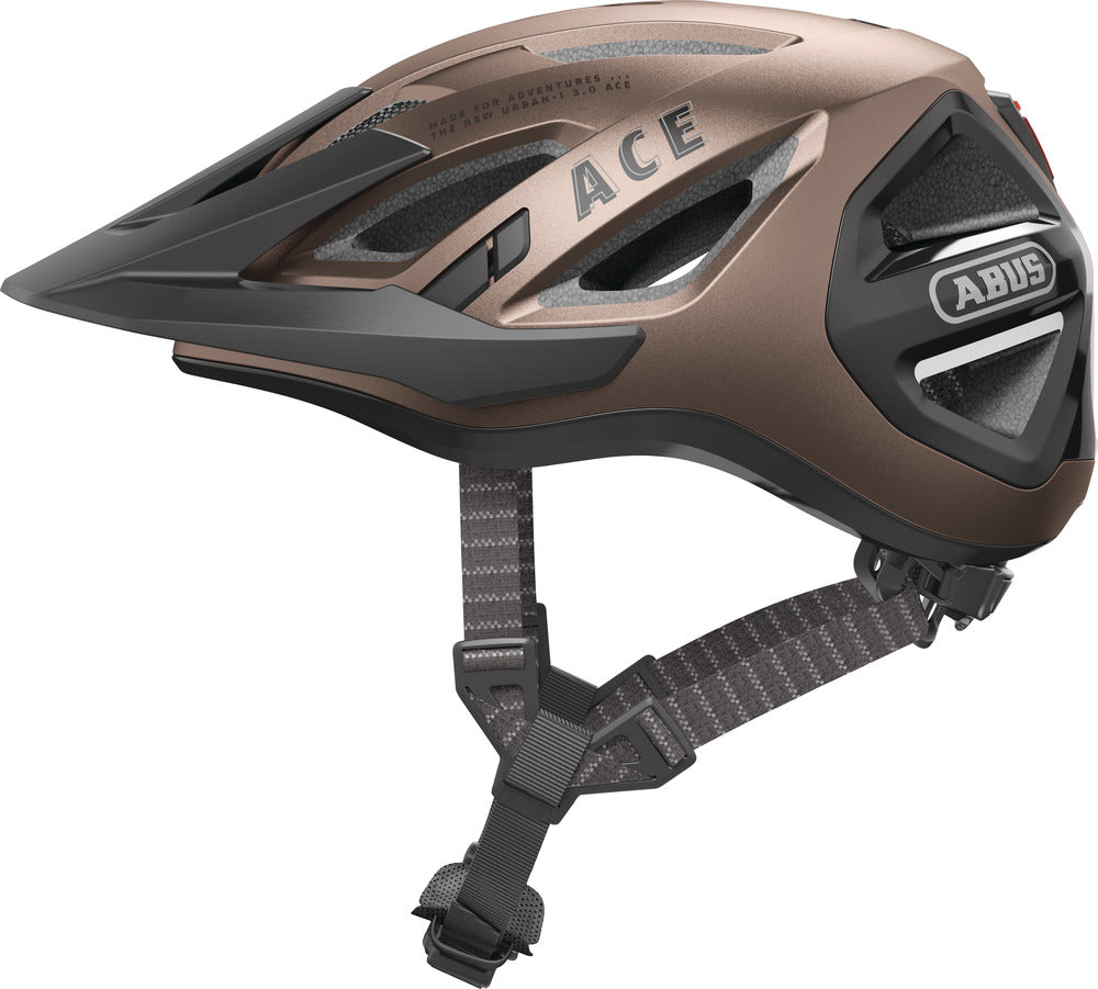 Cykelhjelm Abus Urban-I 3.0 ACE i metallic kobberfarve, set fra siden. Hjelmen har et moderne design og er ideel til bykørsel.