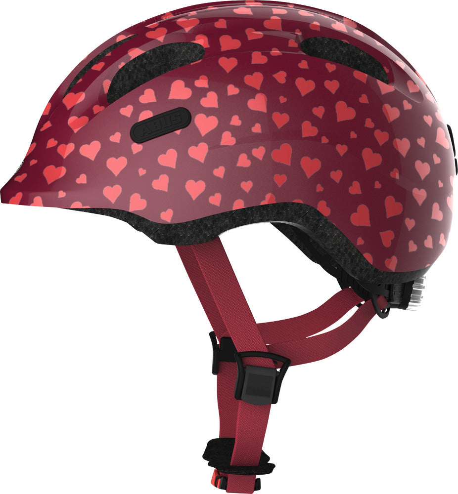 Hjelm Smiley 2.0 i Cherry Heart design med farverig hjerteformet grafik, set fra siden.