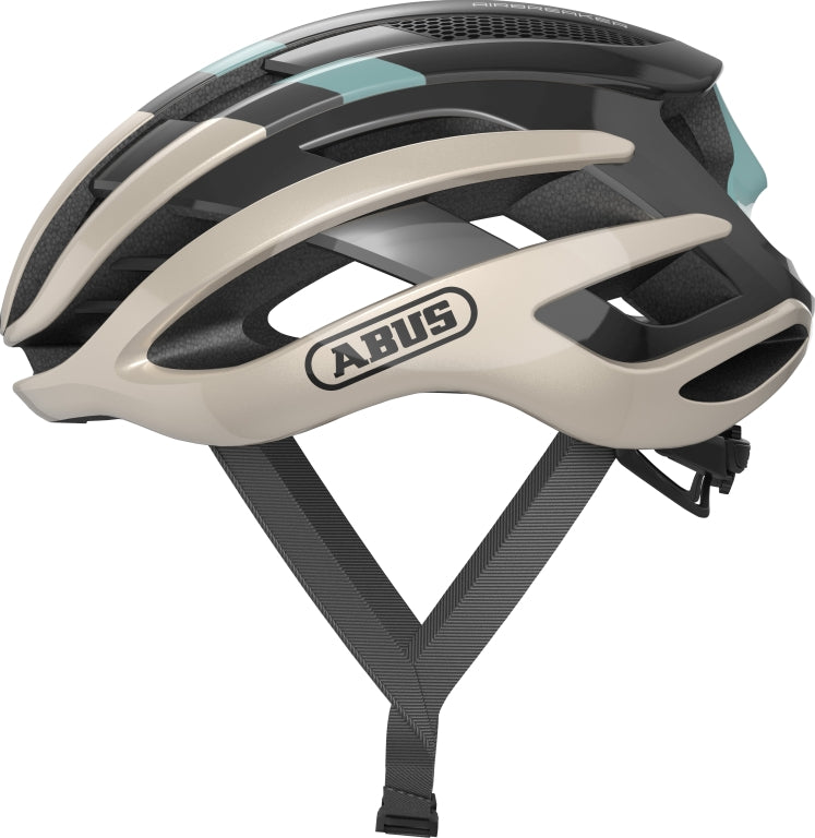 Cykelhjelm Abus Airbreaker i champagne guld, elegant design med aerodynamiske ventilationsåbninger.