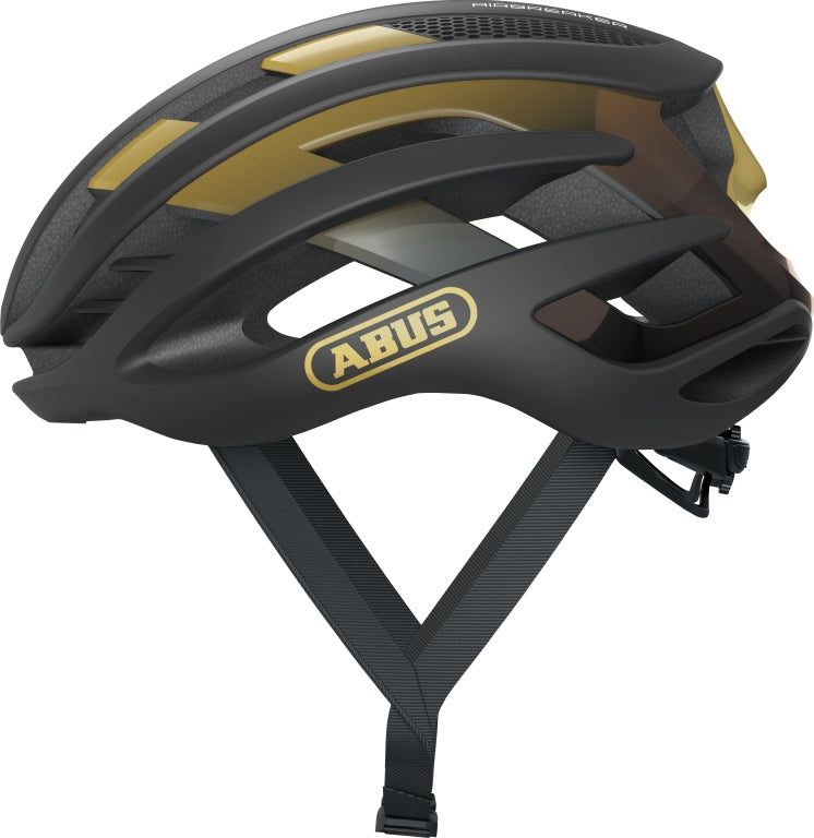 Cykelhjelm Abus Airbreaker i sort og guld, elegant design med ventilationshuller, set fra siden.