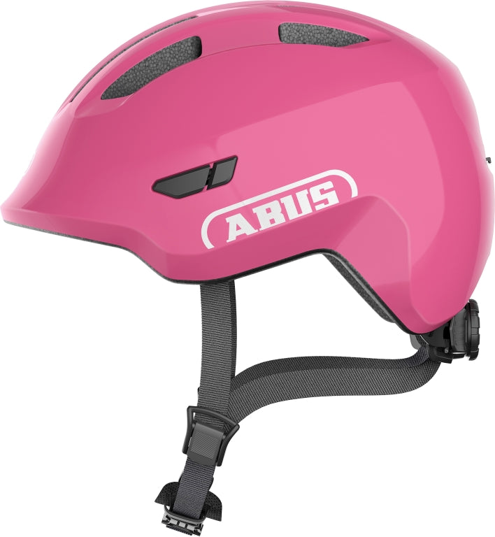 Cykelhjelm Abus Smiley 3.0 Shiny Pink: En skinnende lyserød cykelhjelm med ventilationshuller og justerbar rem.