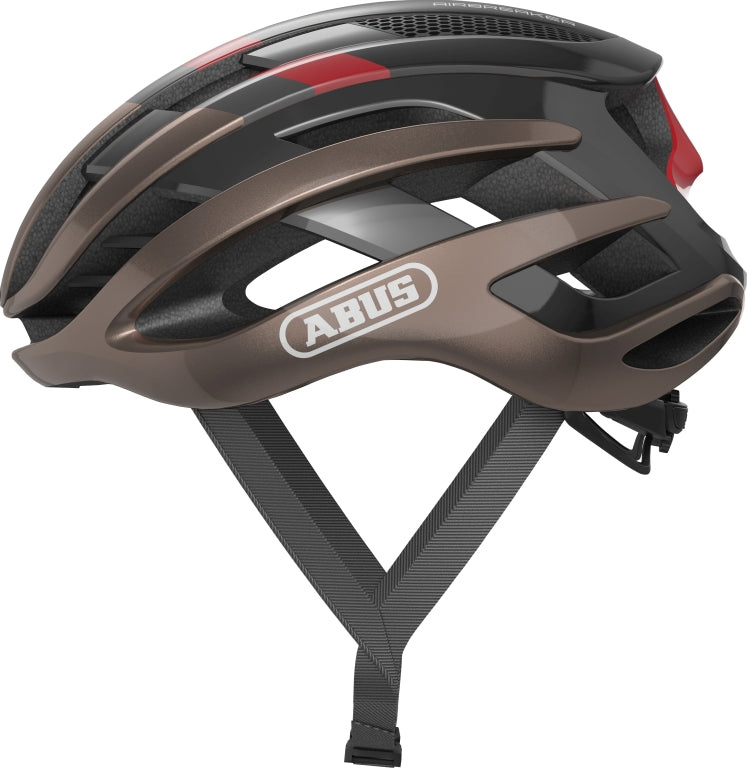 Cykelhjelm Abus Airbreaker i metallic kobber, set fra siden med aerodynamisk design og ventilationsåbninger.