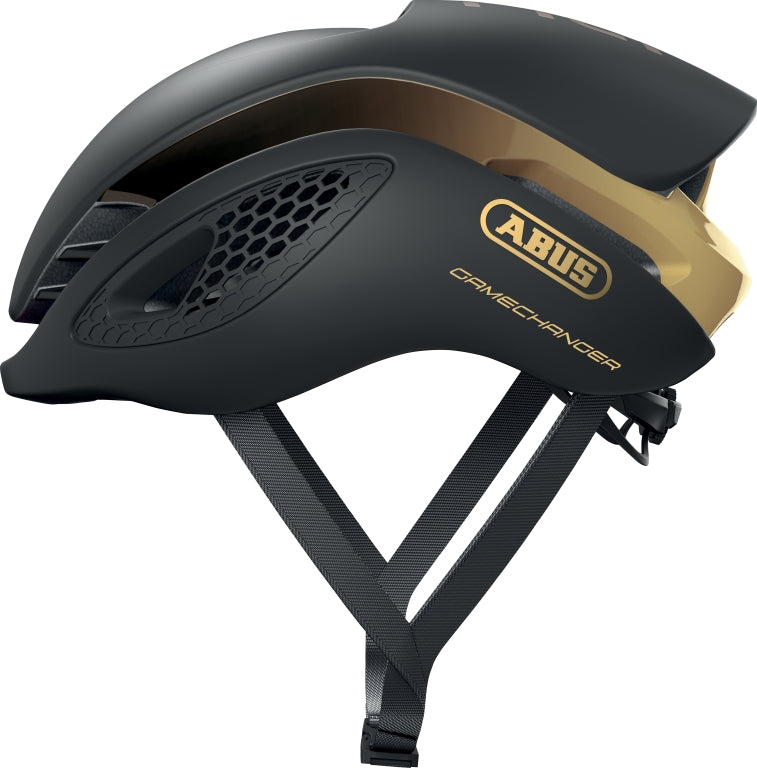 Sort og guld Abus GameChanger cykelhjelm med aerodynamisk design og ventilationsåbninger.