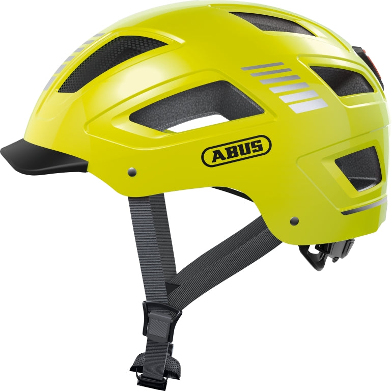 Cykelhjelm Abus Hyban Signal 2.0 i signalgul farve, set fra siden med reflekterende detaljer og justerbar rem.