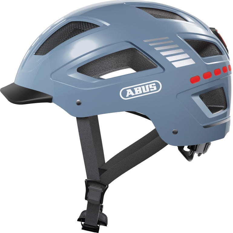 Cykelhjelm Abus Hyban 2.0 LED Shiny Signal Glacier, en skinnende cykelhjelm med LED-lys i en lys blå farve.