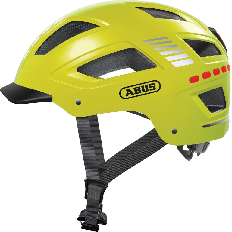 Cykelhjelm Abus Hyban 2.0 LED i skinnende signalgul farve, set fra siden med synlige LED-lys og ventilationshuller.