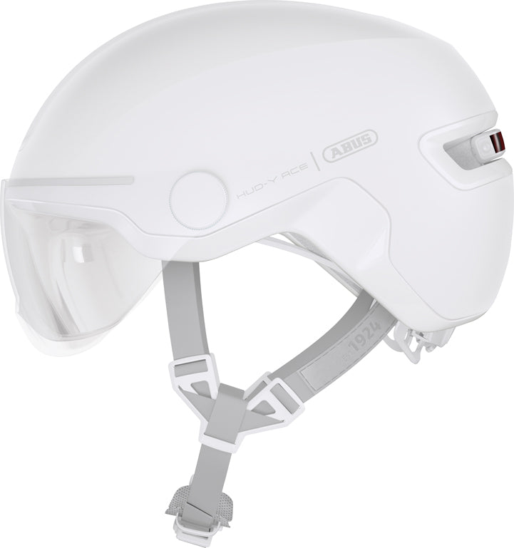 Hjelm Hud-Y Ace Pure White: En hvid cykelhjelm med et strømlinet design, der ligger på en grå baggrund.