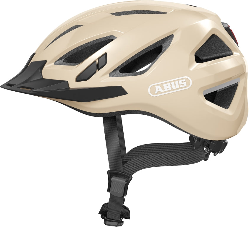 Cykelhjelm Abus Urban-I 3.0 Cannoli Cream, en stilfuld og moderne cykelhjelm i lys cremefarve med ventilationshuller.