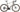 Cykel Principia Gravel C20-24G Shimano GRX820 Kobber står på en grusvej med grønne træer i baggrunden.
